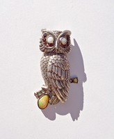 Silver pendant with many stones, patterned with an owl
