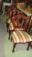 Four stylish dining chairs in good condition.