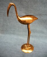 Old long, graceful brass flamingo statue