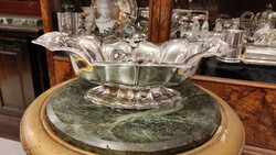 Art deco silver pedestal table in the middle. Fruit holder. Csolnak shape with flower decoration.