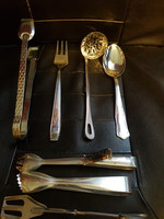 Stainless steel serving tools, pliers, tweezers. Spoon, fork.