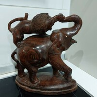 Wood carved elephant with lion