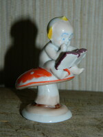 A reading child sitting on a Metzler & Ortloff mushroom