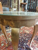 A small wooden table with a glass top.
