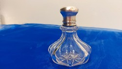 Silver top marked perfume bottle