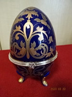 Faberge egg on a cobalt blue background with a gilded pattern. Its height is 12.5 cm. Jokai.