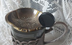 Silver-plated art deco tea strainer with vinyl tongs