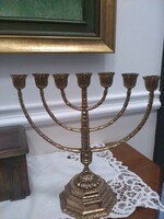 A seven-part menorah candle holder decorated with acanthus leaves