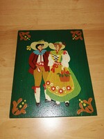 A wooden wall picture of a Dutch couple in folk costume, painted in very nice cheerful colors, 24*30 cm