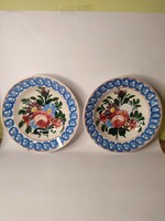 A pair of painted folk wall plates with the old miskolcz mark