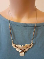 Showy handcrafted necklace with carved mother-of-pearl bird pendant