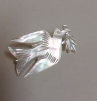 Old dove-shaped mother-of-pearl brooch in good condition