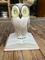 Porcelain owl sitting on a large book