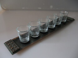 A set of brandy and liqueur glasses on an industrial copper tray with a poker pattern