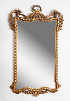 A gilded carved mirror wrapped around with a ribbon pattern