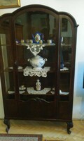 Antique glass display case with curved top.