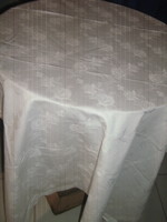 Beautiful damask tablecloth with a snow-white rose pattern