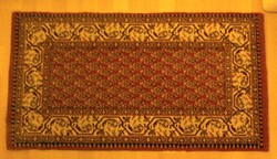 Small carpet with a red pattern