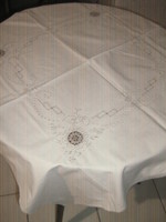 Beautiful hand-crocheted beige tablecloth with floral pattern