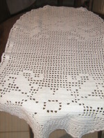 A beautiful hand-crocheted tablecloth with a floral pattern