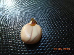 A pendant polished from a rare shell with a gold-colored hook