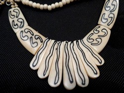 Old bone necklace with signs and pattern