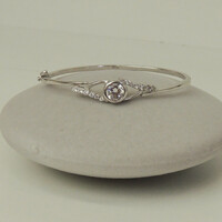 Silver rigid bracelet decorated with water-clear polished stones, with safety lock, hallmark