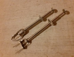 A spring-loaded meat needle and sugar or ice cube tongs in good condition