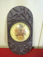 Oval, leather wall decoration, with a dried flower in the middle, height 31 cm. Jokai.