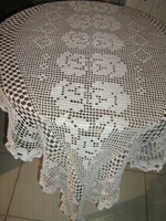 Beautiful special white hand-crocheted boat-shaped lace tablecloth with a flower pattern
