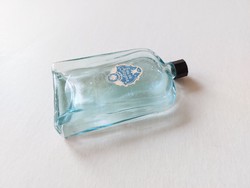 Old perfume bottle with blue cologne bottle label