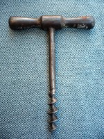 Old corkscrew wine opener with cast iron handle