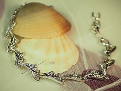 Silver colored (goldfilled) bracelet with a leaf pattern.