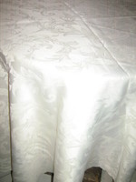 Beautiful butter-colored round silk damask tablecloth with baroque pattern