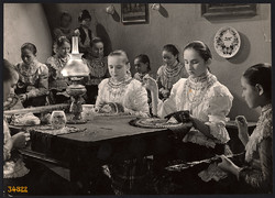 Larger size, photo art work by István Szendrő. Girls around the table in national costume, embroidery k