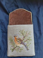 Embroidered comb holder.