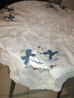 A special tablecloth with a beautiful hand-crocheted edge and a sewn-on goose pattern