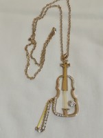 Musical instrument pendant on a long chain.