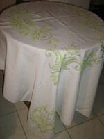 Beautiful cross-stitch hand-embroidered tablecloth with a yellow green baroque pattern