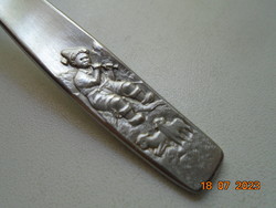 Embossed flute-playing boy with sheep on his handle, stainless steel baby food portioning shovel, oxydex Germany mark