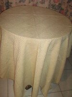 A beautiful beige elegant huge woven tablecloth with a Toledo pattern