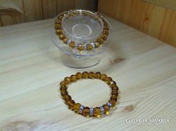 Bracelet made of high-quality polished topaz-colored pearls with solid decoration.