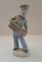 Porcelain figurine of a boy with a tango accordion