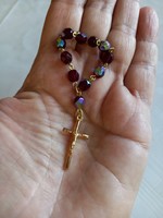 Religious gilded cross on aurora borealis prayer chain