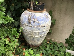 A huge amphora vase with an iron holder