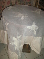 A special tablecloth with a dreamy organza insert, sewn with a rose pattern