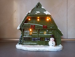 Illuminated house with snowman