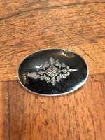 Silver brooch decorated with fire enamel