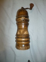 Old wooden pepper grinder coffee grinder with carved decoration