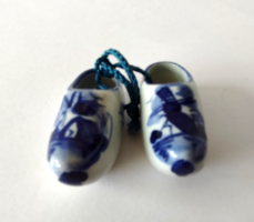 A pair of Dutch delft mini porcelain slippers